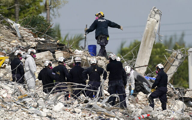 Rescue crews work at the site of the collapsed Champlain Towers South condo building after the remaining structure was demolished Sunday, in Surfside, Florida, on Monday, July 5, 2021. (AP Photo/Lynne Sladky) Rescue crews work at the site of the collapsed Champlain Towers South condo building after the remaining structure was demolished Sunday, in Surfside, Florida, on Monday, July 5, 2021. (AP Photo/Lynne Sladky)