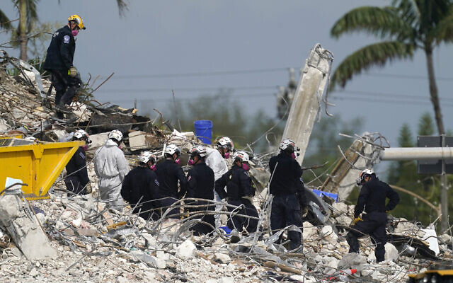 Rescue crews work at the site of the collapsed Champlain Towers South condo building after the remaining structure was demolished Sunday, in Surfside, Fla., Monday, July 5, 2021. (AP Photo/Lynne Sladky) Rescue crews work at the site of the collapsed Champlain Towers South condo building after the remaining structure was demolished Sunday, in Surfside, Fla., Monday, July 5, 2021. (AP Photo/Lynne Sladky)