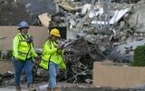 A workers make her way past the rubble and debris of the Champlain Towers South condo in Surfside, Florida on July 6, 2021. (Matias J. Ocner/Miami Herald via AP)