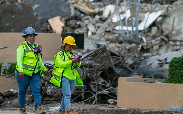 A workers make her way past the rubble and debris of the Champlain Towers South condo in Surfside, Florida on July 6, 2021. (Matias J. Ocner/Miami Herald via AP) A workers make her way past the rubble and debris of the Champlain Towers South condo in Surfside, Florida on July 6, 2021. (Matias J. Ocner/Miami Herald via AP)