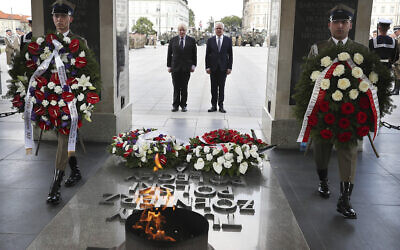 In this Thursday, June 21, 2018 file photo, Britain's Foreign Secretary Boris Johnson lays a wreath at the Tomb of the Unknown Soldier with his Polish counterpart Jacek Czaputowicz in Warsaw, Poland. Poland is reviving plans to reconstruct a historic Warsaw palace where the German Enigma machine codes were first cracked in 1932 and which Nazi German occupying forces blew up in 1944, it was announced Wednesday, July 7, 2021. (AP Photo/Czarek Sokolowski, file)