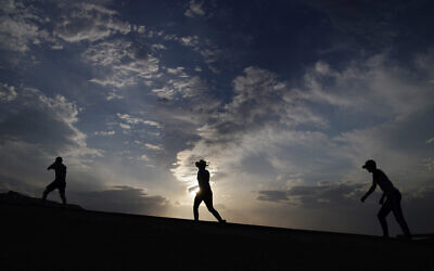 People walk along a trail, July 11, 2021, in Death Valley National Park, California (AP/John Locher)