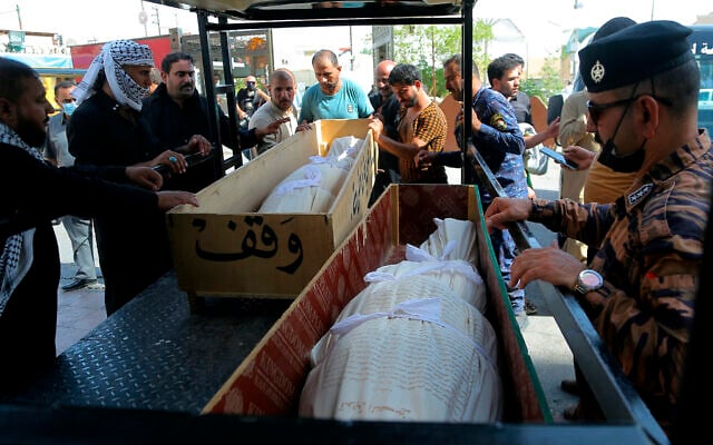 Mourners prepare to bury hospital fire victims in Najaf, Iraq, July 13, 2021 (AP Photo/Anmar Khalil) Mourners prepare to bury hospital fire victims in Najaf, Iraq, July 13, 2021 (AP Photo/Anmar Khalil)