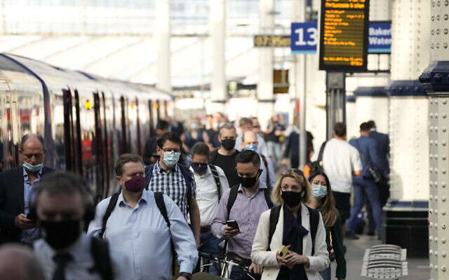 People wear face masks to curb the spread of coronavirus as they disembark from a train during the morning rush hour at Waterloo train station in London, Wednesday, July 14, 2021. (AP Photo/Matt Dunham) People wear face masks to curb the spread of coronavirus as they disembark from a train during the morning rush hour at Waterloo train station in London, Wednesday, July 14, 2021. (AP Photo/Matt Dunham)