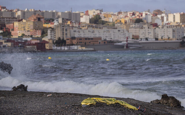 The body of a young man covered with an emergency blanket after being recovered by Spanish police from waters near the border between Morocco and Spain's north African enclave of Ceuta, May 20, 2021. (AP Photo/Bernat Armangue, File) The body of a young man covered with an emergency blanket after being recovered by Spanish police from waters near the border between Morocco and Spain's north African enclave of Ceuta, May 20, 2021. (AP Photo/Bernat Armangue, File)