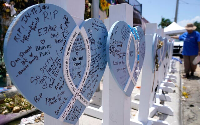 A wooden heart at a makeshift memorial remembers the family of Vishal and Bhavna Patel, who died along with their 1-year-old daughter Aishani, in the collapse of the nearby Champlain Towers South building, Wednesday, July 14, 2021, in Surfside, Fla. Removal and recovery work continues at the site of the partially collapsed condo building, Wednesday, in Surfside. (AP Photo/Lynne Sladky) A wooden heart at a makeshift memorial remembers the family of Vishal and Bhavna Patel, who died along with their 1-year-old daughter Aishani, in the collapse of the nearby Champlain Towers South building, Wednesday, July 14, 2021, in Surfside, Fla. Removal and recovery work continues at the site of the partially collapsed condo building, Wednesday, in Surfside. (AP Photo/Lynne Sladky)