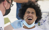 Benny Luna, gets a COVID-19 test from Roberto Gomez, Thursday, July 15, 2021, in Miami. Florida's COVID-19 hospitalization numbers are again increasing, ending months of steady decline that began when widespread vaccinations became available and creating a trend that has epidemiologists worried as the more infectious Delta variant spreads. (AP Photo/Marta Lavandier)