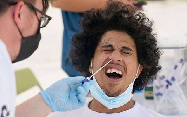 Benny Luna, gets a COVID-19 test from Roberto Gomez, Thursday, July 15, 2021, in Miami. Florida's COVID-19 hospitalization numbers are again increasing, ending months of steady decline that began when widespread vaccinations became available and creating a trend that has epidemiologists worried as the more infectious Delta variant spreads. (AP Photo/Marta Lavandier) Benny Luna, gets a COVID-19 test from Roberto Gomez, Thursday, July 15, 2021, in Miami. Florida's COVID-19 hospitalization numbers are again increasing, ending months of steady decline that began when widespread vaccinations became available and creating a trend that has epidemiologists worried as the more infectious Delta variant spreads. (AP Photo/Marta Lavandier)