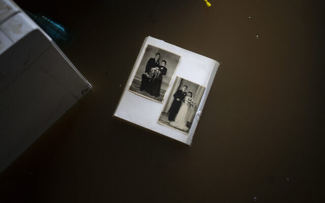 Wedding photos float in water in a flooded basement of a home, in the town of Brommelen, Netherlands, on July 17, 2021. (AP Photo/Bram Janssen) Wedding photos float in water in a flooded basement of a home, in the town of Brommelen, Netherlands, on July 17, 2021. (AP Photo/Bram Janssen)