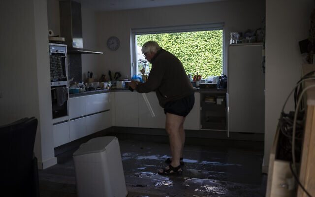 Ijmert Kant assesses the damage in his home in the town of Brommelen, Netherlands, on July 17, 2021. (AP Photo/Bram Janssen) Ijmert Kant assesses the damage in his home in the town of Brommelen, Netherlands, on July 17, 2021. (AP Photo/Bram Janssen)