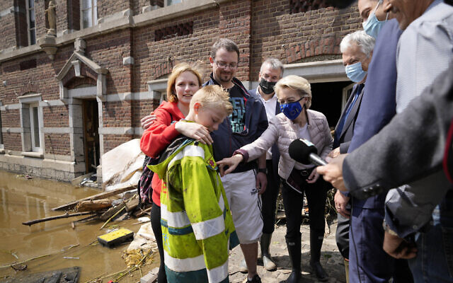 European Commission President Ursula von der Leyen, center, speaks with Madeline Brasseur, 37, Paul Brasseur, 42, and their son Samuel, 12 as she tours the village after flooding in Pepinster, Belgium, on July 17, 2021. (AP Photo/Virginia Mayo) European Commission President Ursula von der Leyen, center, speaks with Madeline Brasseur, 37, Paul Brasseur, 42, and their son Samuel, 12 as she tours the village after flooding in Pepinster, Belgium, on July 17, 2021. (AP Photo/Virginia Mayo)