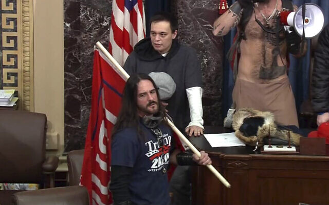 In this file image from US Capitol Police video, Paul Allard Hodgkins, 38, of Tampa, Fla., front, stands in the well on the floor of the US Senate on Jan. 6, 2021, at the Capitol in Washington. (U.S. Capitol Police via AP) In this file image from US Capitol Police video, Paul Allard Hodgkins, 38, of Tampa, Fla., front, stands in the well on the floor of the US Senate on Jan. 6, 2021, at the Capitol in Washington. (U.S. Capitol Police via AP)