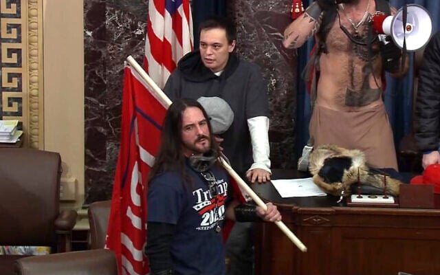 In this file image from US Capitol Police video, Paul Allard Hodgkins, 38, of Tampa, Florida, front, stands in the well on the floor of the US Senate on Jan. 6, 2021, at the Capitol in Washington. (U.S. Capitol Police via AP, File) In this file image from US Capitol Police video, Paul Allard Hodgkins, 38, of Tampa, Florida, front, stands in the well on the floor of the US Senate on Jan. 6, 2021, at the Capitol in Washington. (U.S. Capitol Police via AP, File)