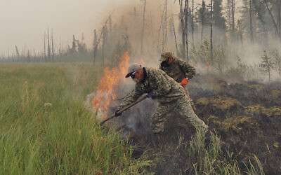Volunteers douse a forest fire in the republic of Sakha also known as Yakutia, Russia Far East, July 17, 2021. (AP/Ivan Nikiforov)