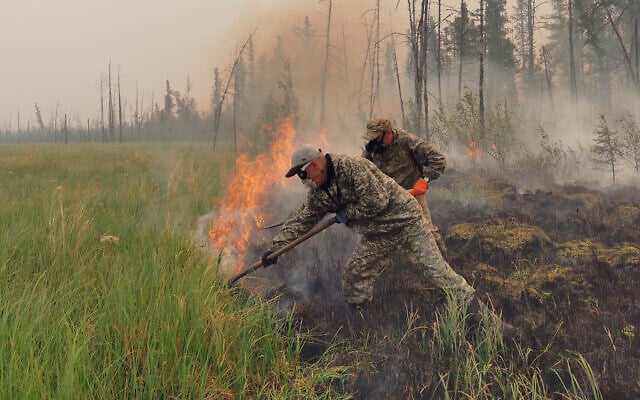 Volunteers douse a forest fire in the republic of Sakha also known as Yakutia, Russia Far East, July 17, 2021. (AP/Ivan Nikiforov)