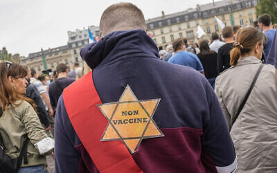 Illustrative: A yellow star that reads 'not vaccinated' is attached to the back of a protester during a rally in Paris, July 17, 2021. (AP Photo/Michel Euler, File)
