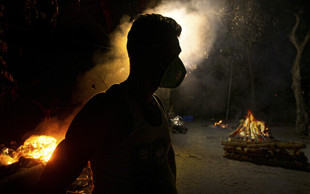 Illustrative: In this Septsember 14, 2020, file photo, Ramananda Sarkar, 43, who has cremated more than 450 COVID-19 victims stands by burning funeral pyres of COVID-19 victims in Gauhati, India. (AP Photo/Anupam Nath, File) Illustrative: In this Septsember 14, 2020, file photo, Ramananda Sarkar, 43, who has cremated more than 450 COVID-19 victims stands by burning funeral pyres of COVID-19 victims in Gauhati, India. (AP Photo/Anupam Nath, File)