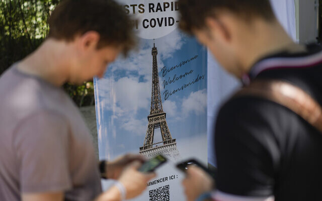 Visitors register for COVID-19 tests at the Eiffel Tower in Paris, July 21, 2021. (AP Photo/Daniel Cole)
