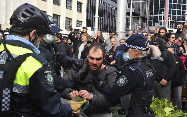 A protester is arrested by police at a demonstration at Sydney Town Hall during a 'World Wide Rally For Freedom' anti-lockdown rally in Sydney, on Saturday, July 24, 2021. (Mick Tsikas/AAP Image via AP)