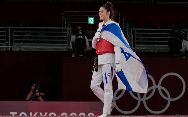 Israel's Avishag Semberg walks off the ring after defeating Turkey's Rukiye Yıldırım to win a bronze medal during the women's 49kg taekwondo match at the 2020 Summer Olympics, on Saturday, July 24, 2021, in Tokyo, Japan. (AP Photo/Themba Hadebe). Israel's Avishag Semberg walks off the ring after defeating Turkey's Rukiye Yıldırım to win a bronze medal during the women's 49kg taekwondo match at the 2020 Summer Olympics, on Saturday, July 24, 2021, in Tokyo, Japan. (AP Photo/Themba Hadebe).