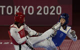Kimia Alizadeh Zonoozi, Refugee Olympic Team, left, attacks China's Zhou Lijun during the taekwondo women's 57kg match at the 2020 Summer Olympics, July 25, 2021, in Tokyo, Japan. (AP Photo/Themba Hadebe)
