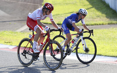 Anna Plichta of Poland and Omer Shapira of Israel compete in the women's cycling road race at the 2020 Summer Olympics, Sunday, July 25, 2021, in Oyama, Japan. (Michael Steele/Pool Photo via AP)