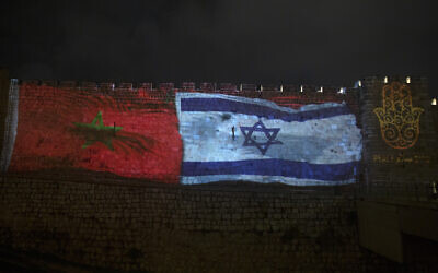 The national flags of Israel and Morocco are projected on the walls of the Old City of Jerusalem, along with the word "peace," in English, Hebrew, and Arabic, on December 23, 2020. (AP Photo/Maya Alleruzzo, File)