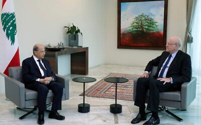 Lebanese President Michel Aoun, left, meets with former Lebanese Prime Minister Najib Mikati, at the presidential palace, in Baabda, east of Beirut, Lebanon, July 26, 2021. (Dalati Nohra/Lebanese Official Government via AP)