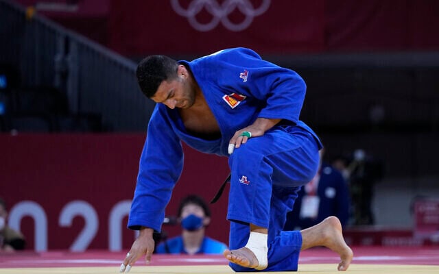 Iranian defector Saeid Mollaei, competing under a Mongolian flag, reacts after losing to Takanori Nagase of Japan, unseen, during the men -81kg final of the judo match at the 2020 Summer Olympics in Tokyo, Japan, on July 27, 2021. (AP Photo/Vincent Thian)