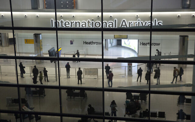 In this January 26, 2021 photo, people in the International Arrivals area at Heathrow Airport in London, during England's coronavirus lockdown. (AP/Matt Dunham) In this January 26, 2021 photo, people in the International Arrivals area at Heathrow Airport in London, during England's coronavirus lockdown. (AP/Matt Dunham)