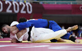 Peter Paltchik of Israel, left, and Aaron Wolf of Japan compete in the men's -100kg quarterfinal round judo match of the 2020 Summer Olympics in Tokyo, Japan, July 29, 2021. (AP/Vincent Thian)