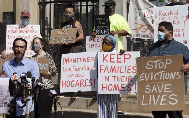 People from a coalition of housing justice groups hold signs protesting evictions during a news conference outside the Statehouse, July 30, 2021, in Boston. (AP Photo/Michael Dwyer) People from a coalition of housing justice groups hold signs protesting evictions during a news conference outside the Statehouse, July 30, 2021, in Boston. (AP Photo/Michael Dwyer)