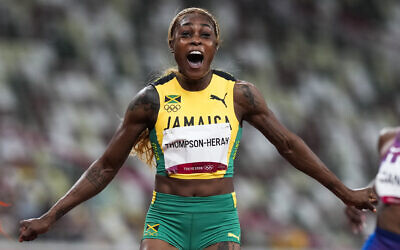 Elaine Thompson-Herah of Jamaica wins the women's 100-meter final at the 2020 Summer Olympics, on July 31, 2021, in Tokyo. (AP Photo/Martin Meissner)