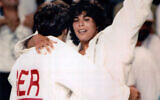 Israeli Olympic judoka Yael Arad, right, celebrates and hugs her German opponent, Frauke Eickoff, after winning the semi-final match at the Barcelona  Olympics, on July 30, 1992. (AP Photo)