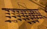 Dozens of guns seized during a smuggling operation from Lebanon, on July 10, 2021. (Israel Defense Forces)