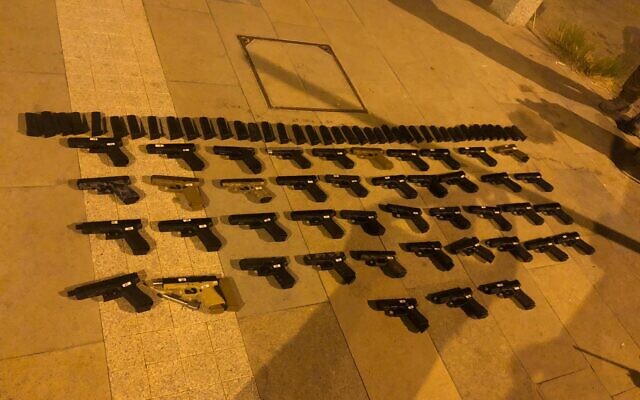 Dozens of guns seized during a smuggling operation from Lebanon, on July 10, 2021. (Israel Defense Forces) Dozens of guns seized during a smuggling operation from Lebanon, on July 10, 2021. (Israel Defense Forces)