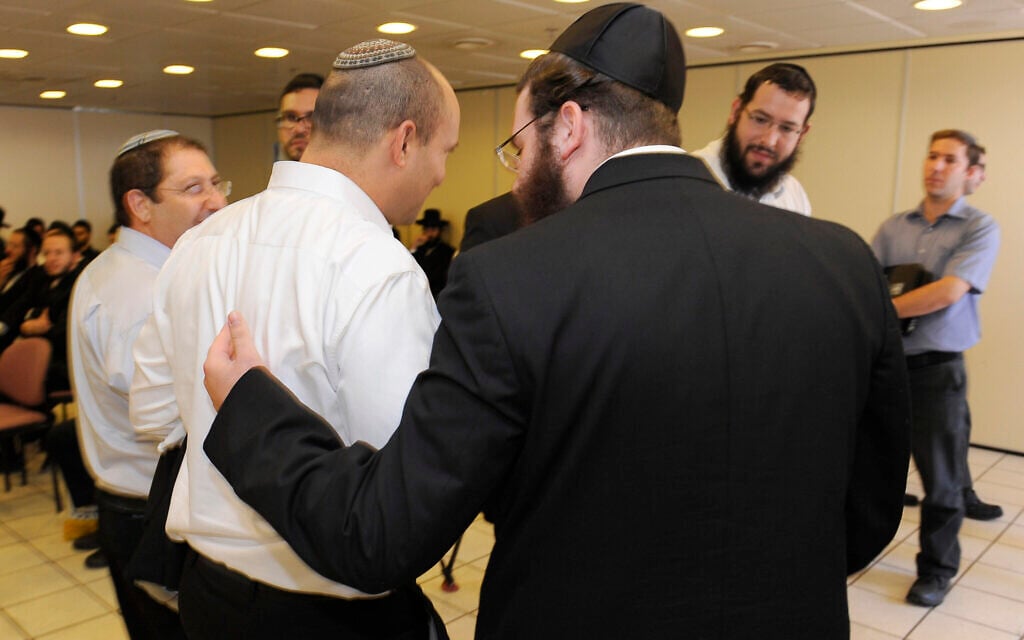 An ultra-Orthodox Jewish man speaks with then-Economy Minister Naftali Bennett following a discussion about drafting ultra-Orthodox men to service in the Israeli army in the Yad Sara building in Jerusalem, on June 11, 2013. (Zuzana Janku/Flash 90) An ultra-Orthodox Jewish man speaks with then-Economy Minister Naftali Bennett following a discussion about drafting ultra-Orthodox men to service in the Israeli army in the Yad Sara building in Jerusalem, on June 11, 2013. (Zuzana Janku/Flash 90)