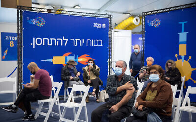 Israelis wait to recieve a COVID-19 vaccine, at a vaccination center operated by the Tel Aviv Municipality with Tel Aviv Sourasky Medical Center (Ichilov), at Rabin Square in Tel Aviv, December 31, 2020. (Miriam ALster/Flash90) Israelis wait to recieve a COVID-19 vaccine, at a vaccination center operated by the Tel Aviv Municipality with Tel Aviv Sourasky Medical Center (Ichilov), at Rabin Square in Tel Aviv, December 31, 2020. (Miriam ALster/Flash90)