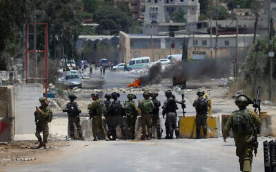 Palestinian protester hurls stones towards Israeli troops during clashes at a protest in the West Bank village of Beita, near Nablus on June 08, 2021. Photo by Nasser Ishtayeh/Flash90
