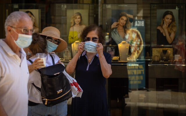 People walk face masks in Jerusalem on June 27, 2021. (Olivier Fitoussi/Flash90)