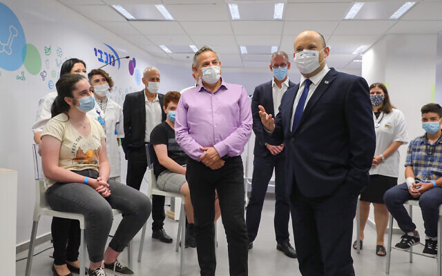 Prime Minister Naftali Bennet and Health Minister Nitzan Horowitz attend a press conference at a Maccabi vaccine center in Holon on June 29 2021. (Marc Israel Sellem/POOL via Flash90) Prime Minister Naftali Bennet and Health Minister Nitzan Horowitz attend a press conference at a Maccabi vaccine center in Holon on June 29 2021. (Marc Israel Sellem/POOL via Flash90)