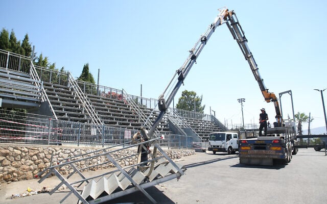 Workers dismantle a temporary structure at a compound in Meron, northern Israel, on June 30, 2021. (David Cohen/Flash90) Workers dismantle a temporary structure at a compound in Meron, northern Israel, on June 30, 2021. (David Cohen/Flash90)