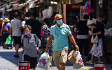 People walk some with face masks in Jerusalem on July 4, 2021. (Olivier Fitoussi/Flash90)