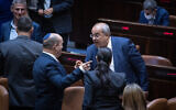 Prime Minister Naftali Bennett (L) speaks with Joint List MK Ahmad Tibi after a Knesset vote rejected an extension of the Palestinian family reunification law, in Jerusalem, July 6, 2021. (Yonatan Sindel/Flash90)
