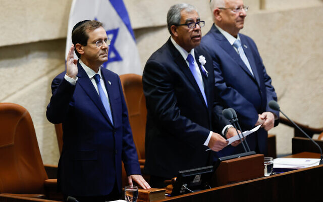 President Isaac Herzog (L) is sworn in at the Knesset in Jerusalem on July 7, 2021. To his right are Knesset Speaker Mickey Levy and outgoing President Reuven Rivlin. (Yonatan Sindel/Flash90) President Isaac Herzog (L) is sworn in at the Knesset in Jerusalem on July 7, 2021. To his right are Knesset Speaker Mickey Levy and outgoing President Reuven Rivlin. (Yonatan Sindel/Flash90)