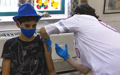 A child receives a COVID-19 vaccine injection in Jerusalem, July 8, 2021. (Olivier Fitoussi/Flash90)