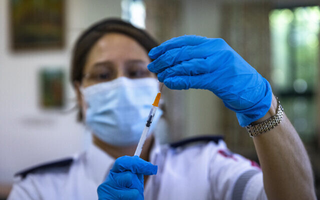 A medic prepares a Covid-19 vaccine injection, at a vaccination center in Jerusalem, July 8, 2021. (Olivier Fitoussi/Flash90) A medic prepares a Covid-19 vaccine injection, at a vaccination center in Jerusalem, July 8, 2021. (Olivier Fitoussi/Flash90)