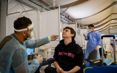Medical technicians test passengers for COVID-19 at the Ben Gurion International Airport near Tel Aviv on July 12, 2021. (Flash90)