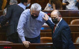 Prime Minister Naftali Bennett (R) and Yisrael Beytenu MK Eli Avidar attend a plenum session in the Knesset, on July 12, 2021. (Olivier Fitoussi/Flash90)