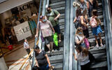 People wear protective face masks as they shop at Azrieli Mall in Tel Aviv on July 13, 2021. (Miriam Alster/FLASH90)